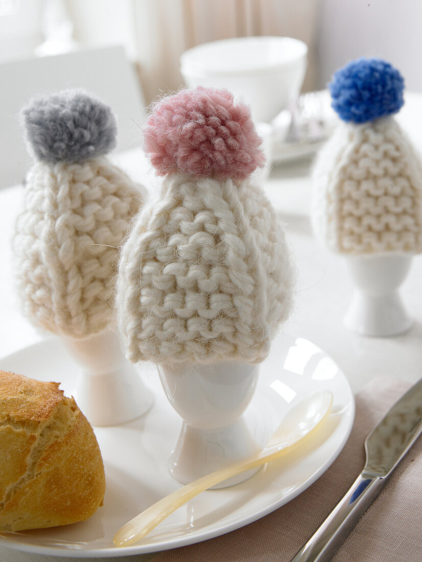 Close-up of knitted bobble hats of eggs