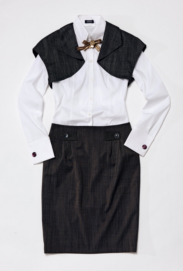 White blouse with black bolero jacket on white background