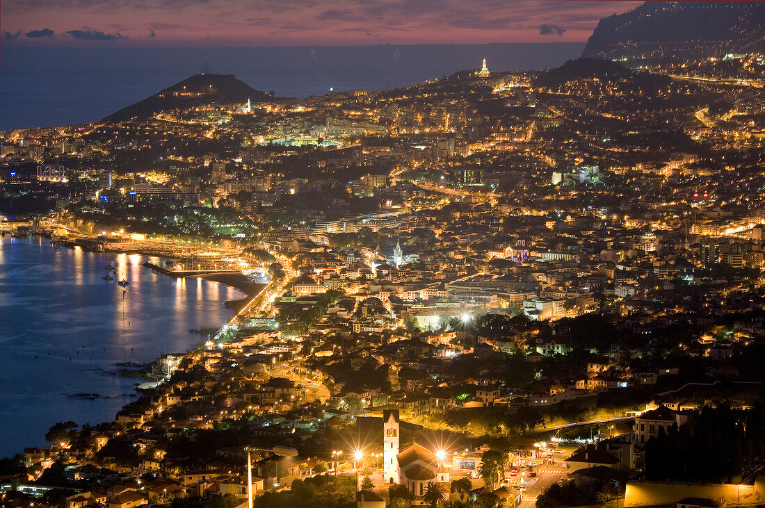 Aerial view of illuminated Funchal harbour and city at dusk, Madeira, Portugal