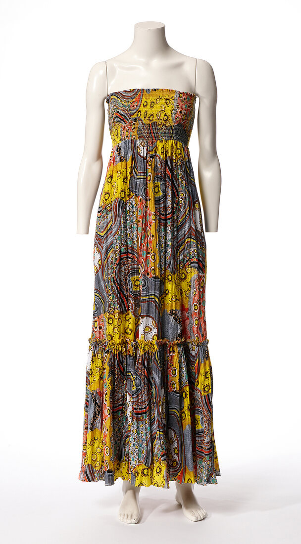 Long colourful patterned bustier dress on mannequin against white background