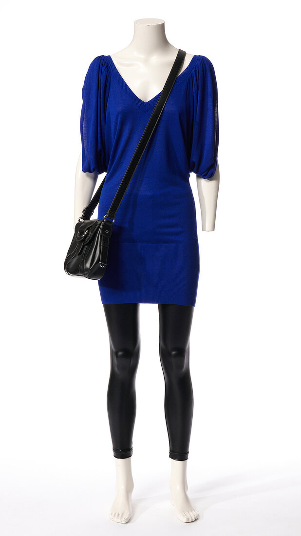 Blue knitted dress and leggings with cross bag on mannequin against white background
