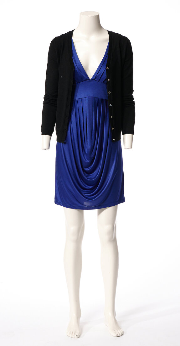 Black cardigan over blue stain dress on mannequin against white background 