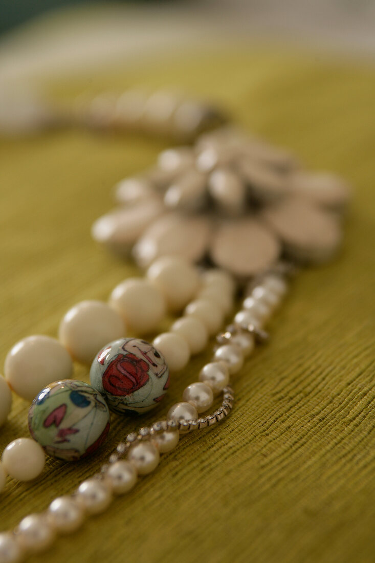 Close-up of pearl necklace on wooden background