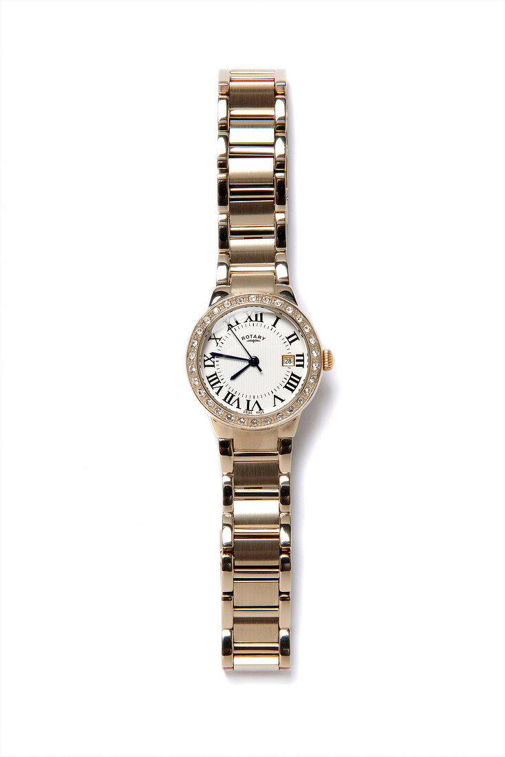 Golden wrist watch with zirconia on white background