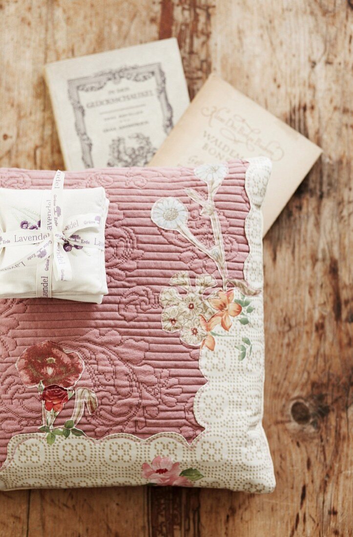 Scented sachets on floral scatter cushion