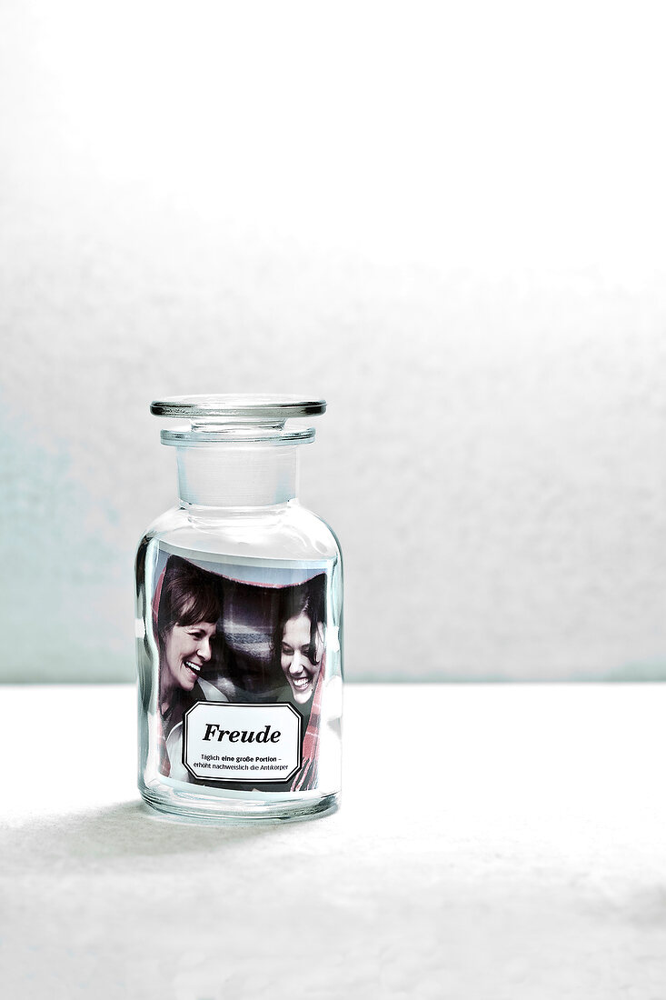 Glass bottle with picture of women laughing in front 