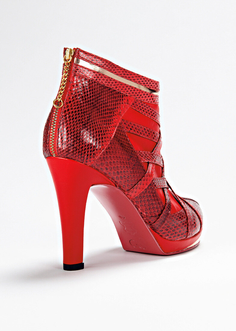 Smooth leather and imitation snakeskin ankle boot in red colour on white background
