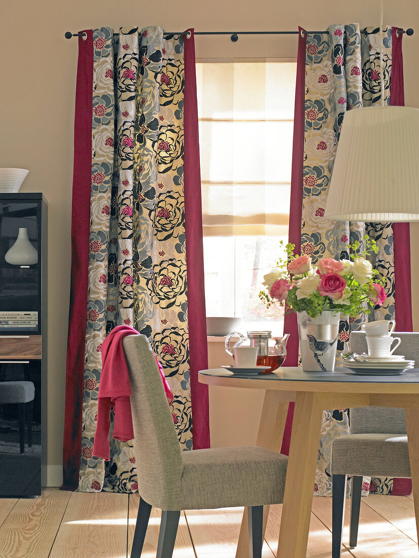 Gray and purple floral printed curtain, table and chair in dining room