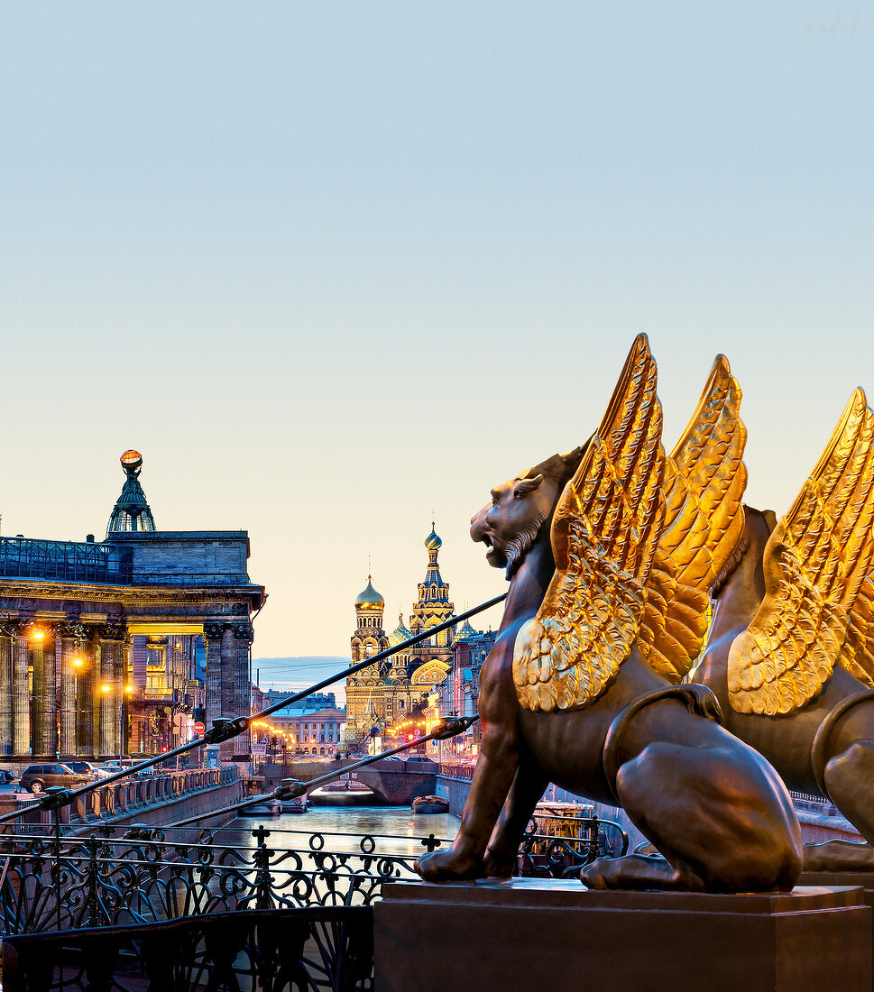 View of Bank Bridge lions and cityscape at dusk in Saint Petersburg, Russia