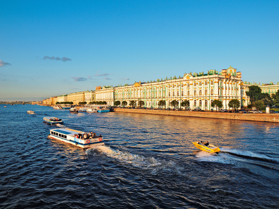 View of boats in Neva River and Hermitage Museum in St. Petersburg, Russia