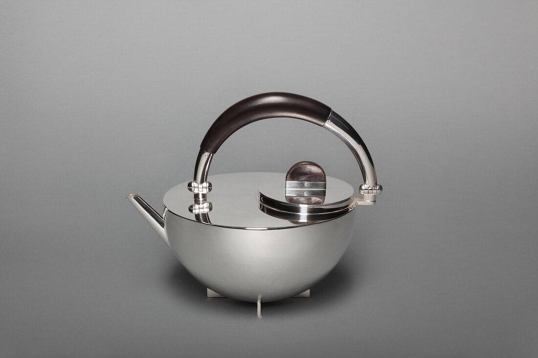 Close-up of silver teapot on gray background