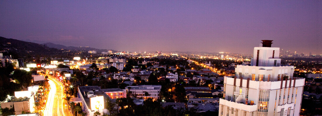 Panoramic view of illuminated city at dusk