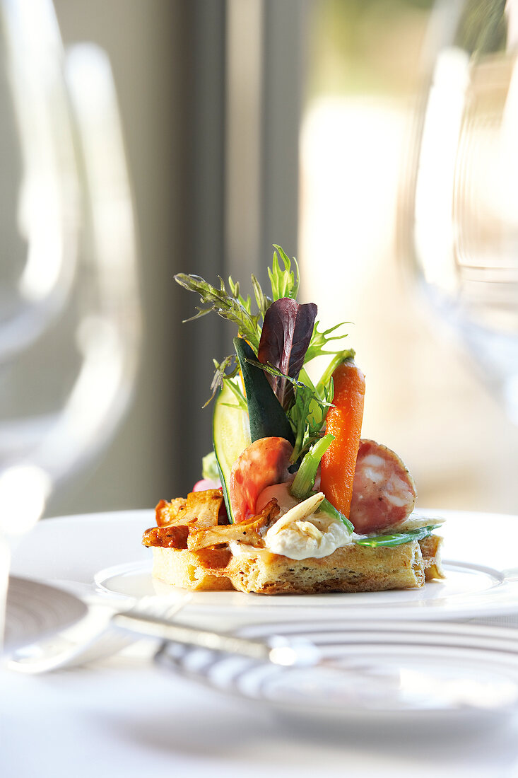 Close-up of ardennes salad with waffles, sausage, carrots and chanterelles