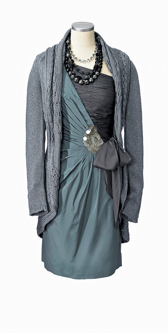 gray coat over festive dress with side knot on mannequin