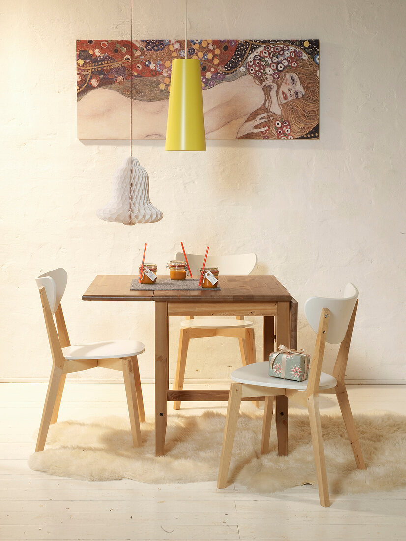 Dinning area with folding table, chairs, lamp and picture on wall