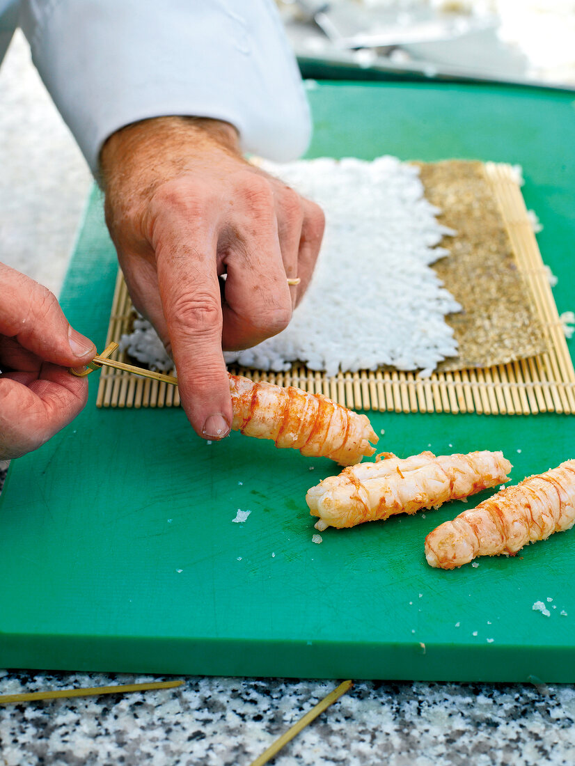 Close-up of putting langoustines on a skewer
