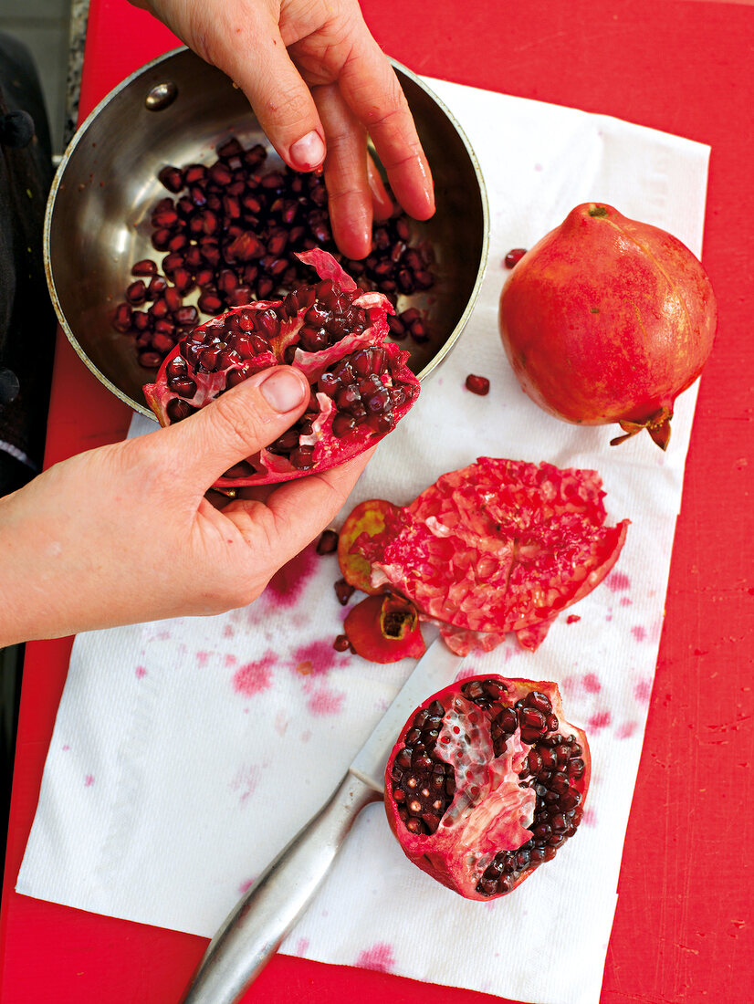 Deseeding pomegranate in bowl