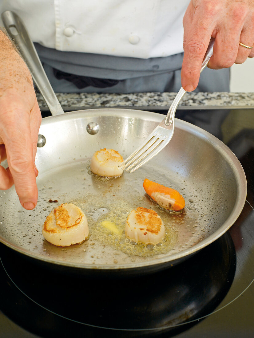 Flesh and roe being fried in pan