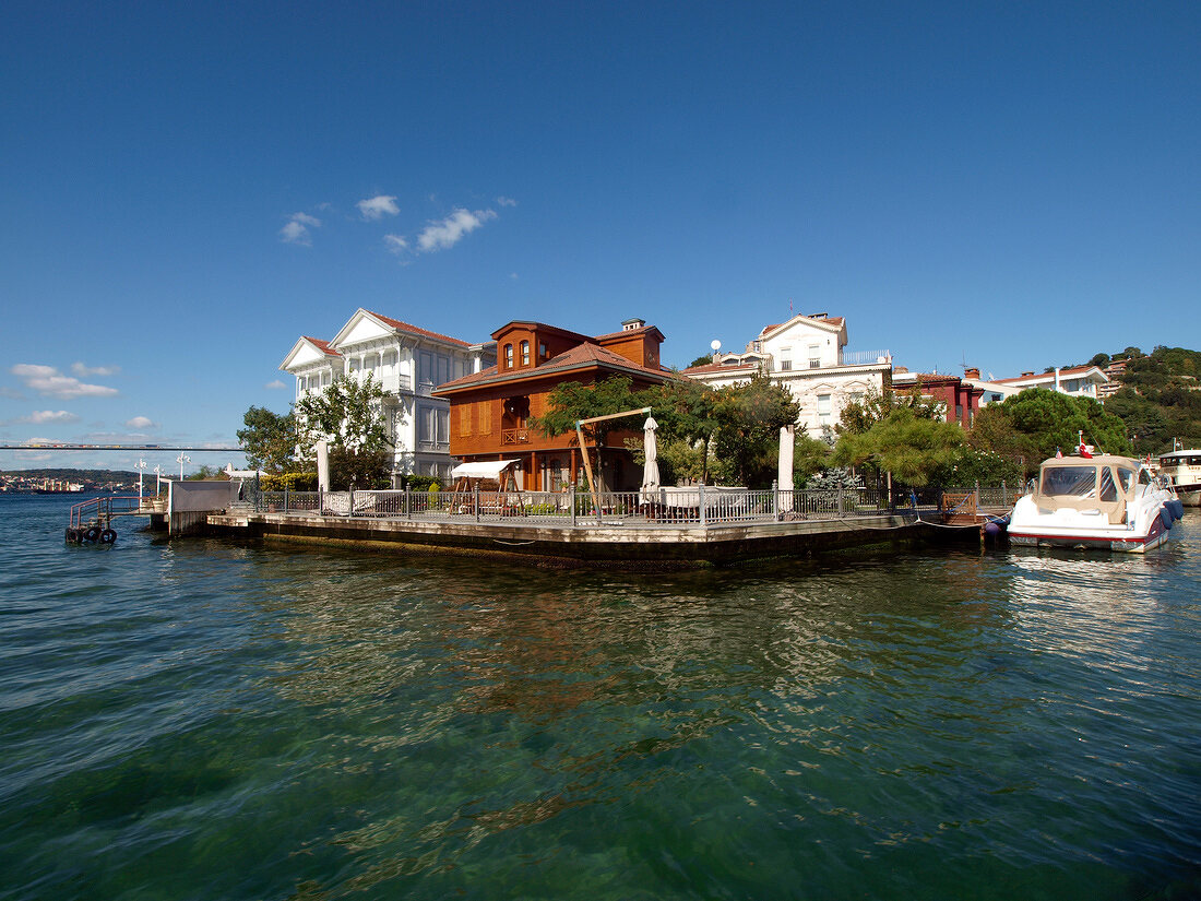 View of wooden houses with blue sky on Bosphorus shore in Istanbul, Turkey
