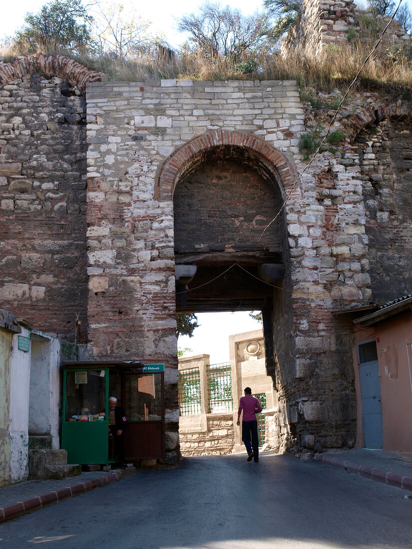 View of man passing through archway made of stone in Istanbul, Turkey