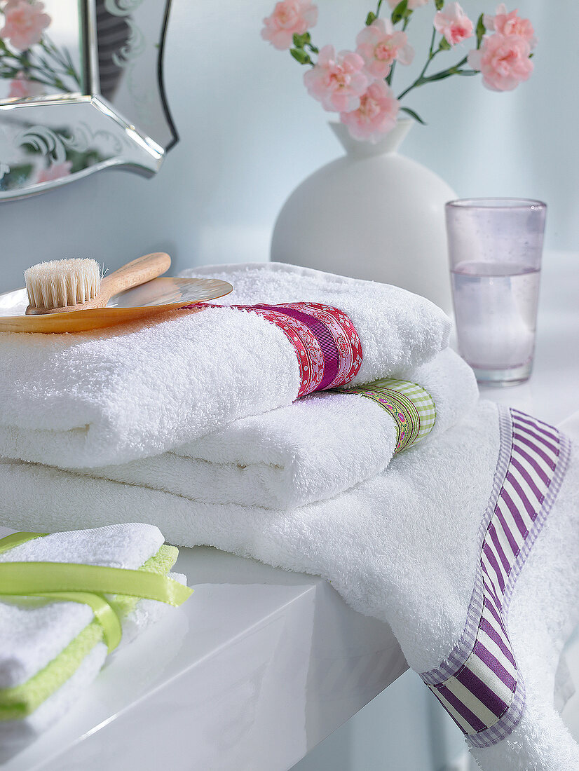 Border patterned white towel with brush