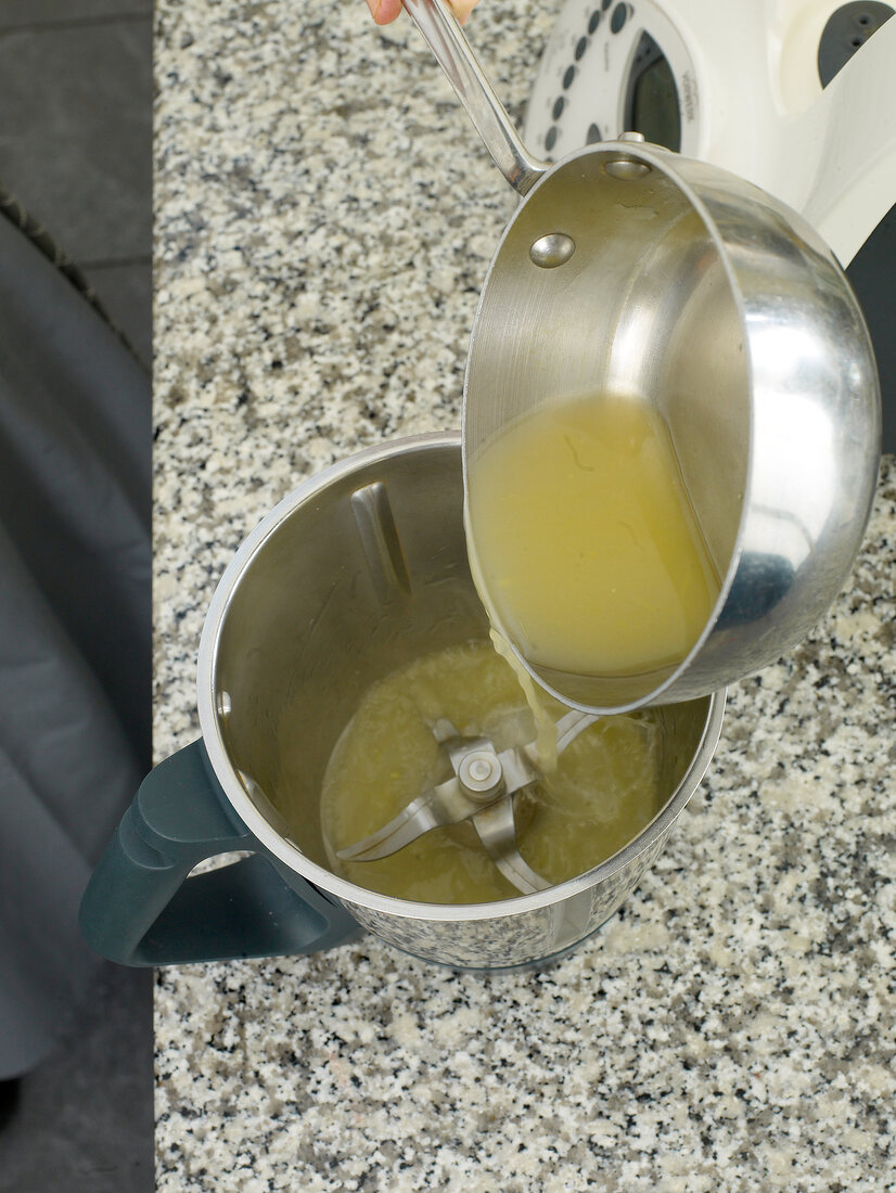Close-up of liquid being poured in grinder jar