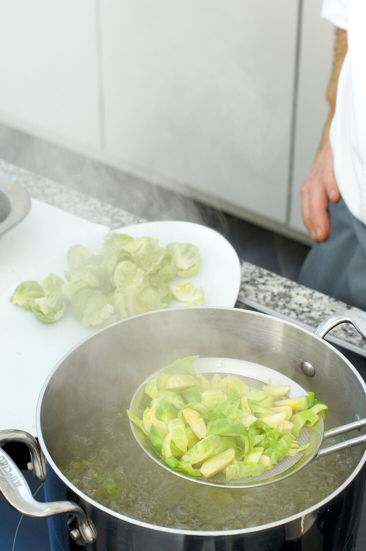 Brussels sprouts being cooked in water