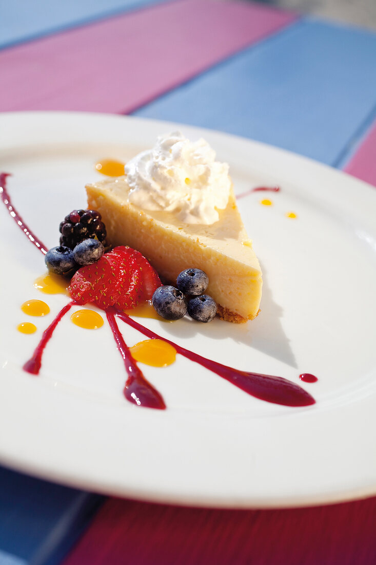 Close-up of key lime pie with fresh berries on plate