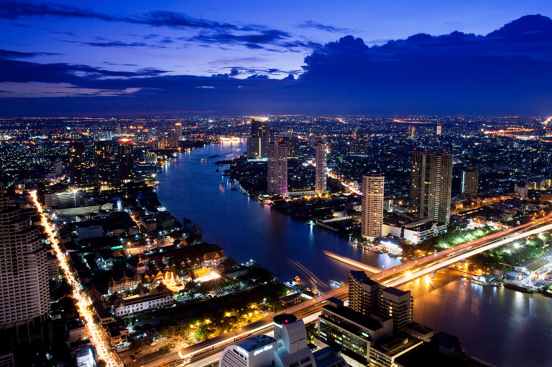 View of Bangkok cityscape with bridge and river at dusk, Thailand