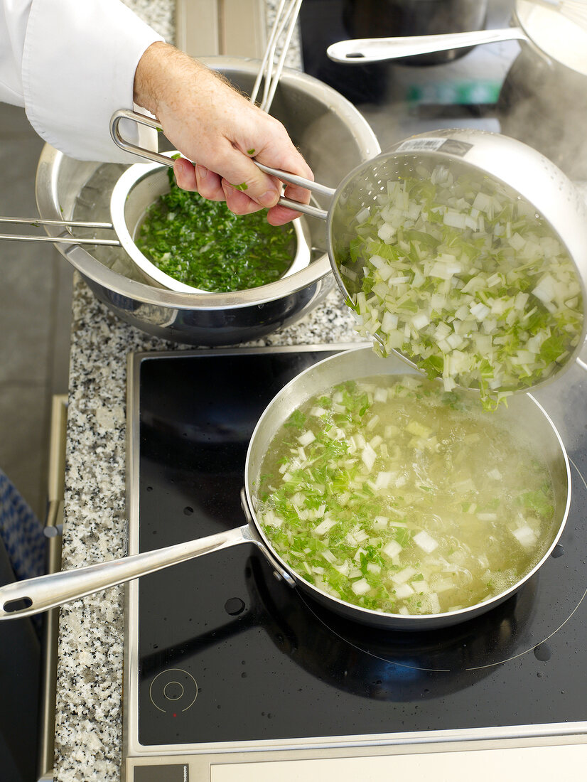 Turnip green being cooked in sauce pan