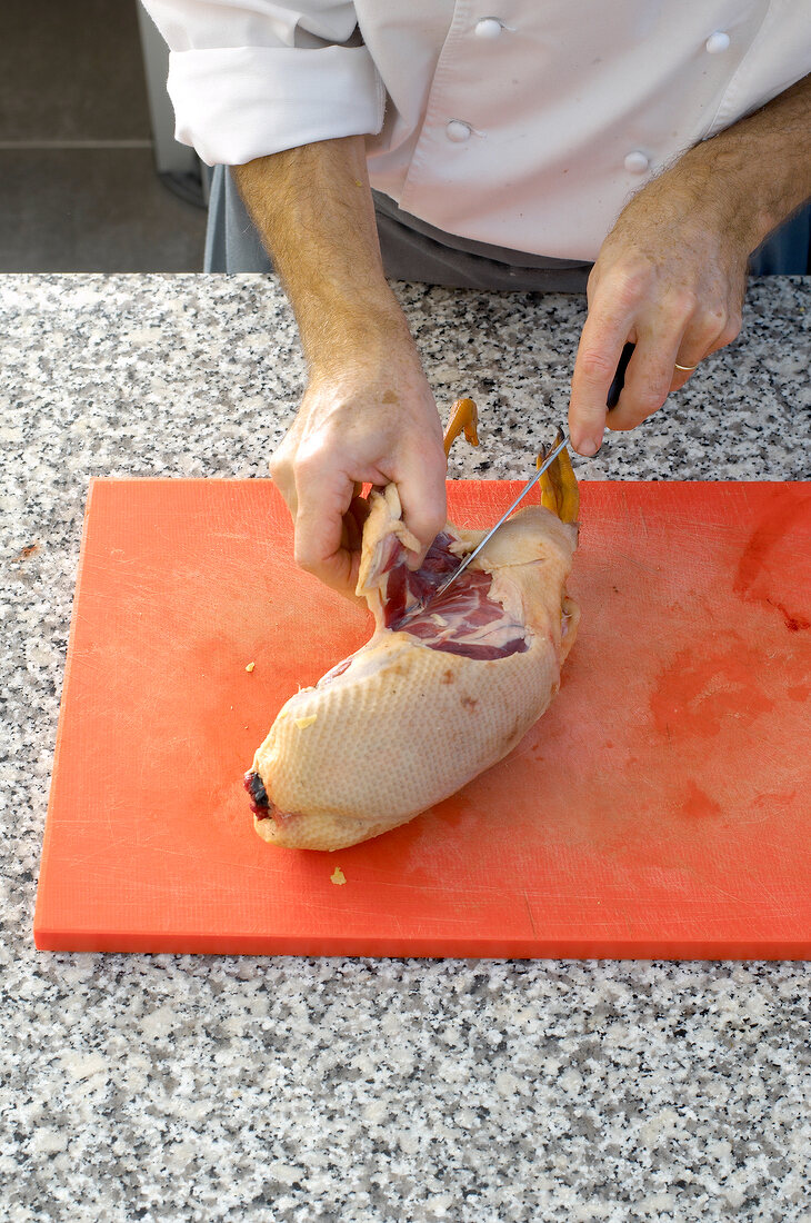 Cutting duck on cutting board