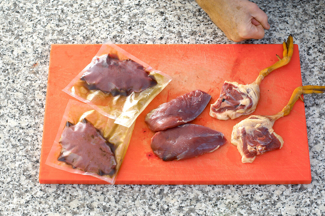 Separated pieces of duck on cutting board