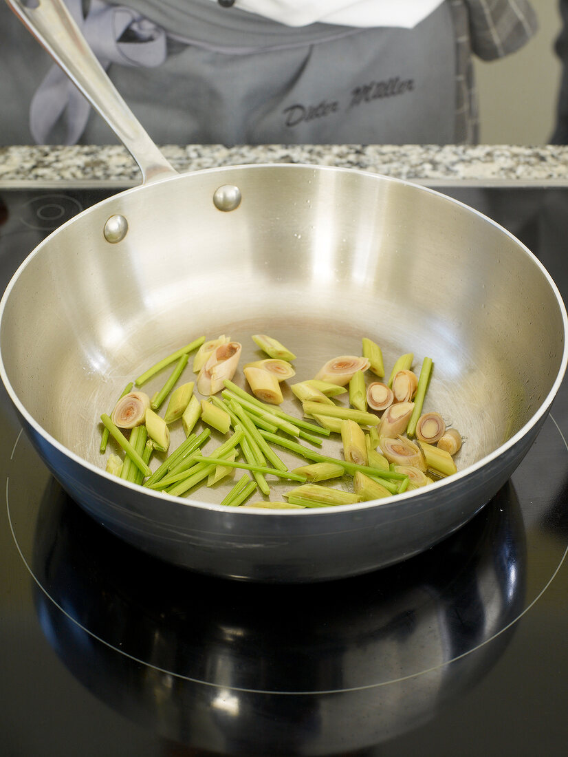 Cut pieces of lemon grass in saucepan