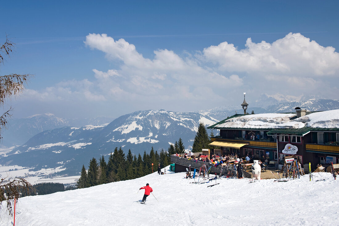 View of people skiing and Angerer Alm in Kitzbuhel, Tyrol, Austria