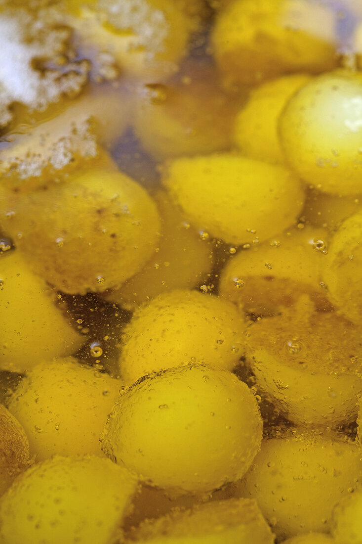 Close-up of potato balls being cooked in butter