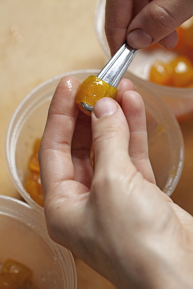 Close-up of pulp of kumquats being scrapped