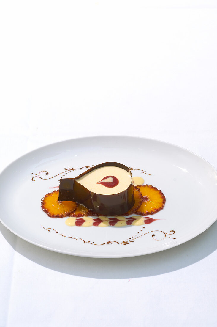 Coffee mousse with pineapple slices on decorated plate
