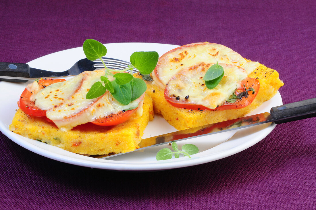 Tomato slices with polenta on plate