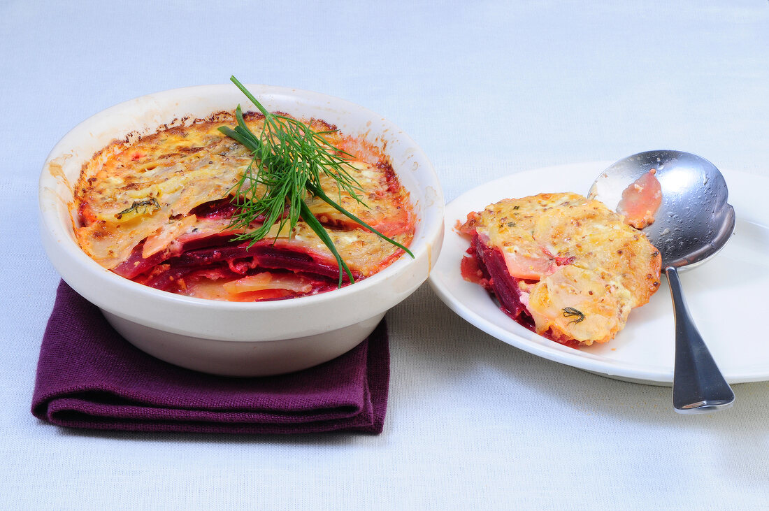 Baked potatoes and beetroot in bowl and plate