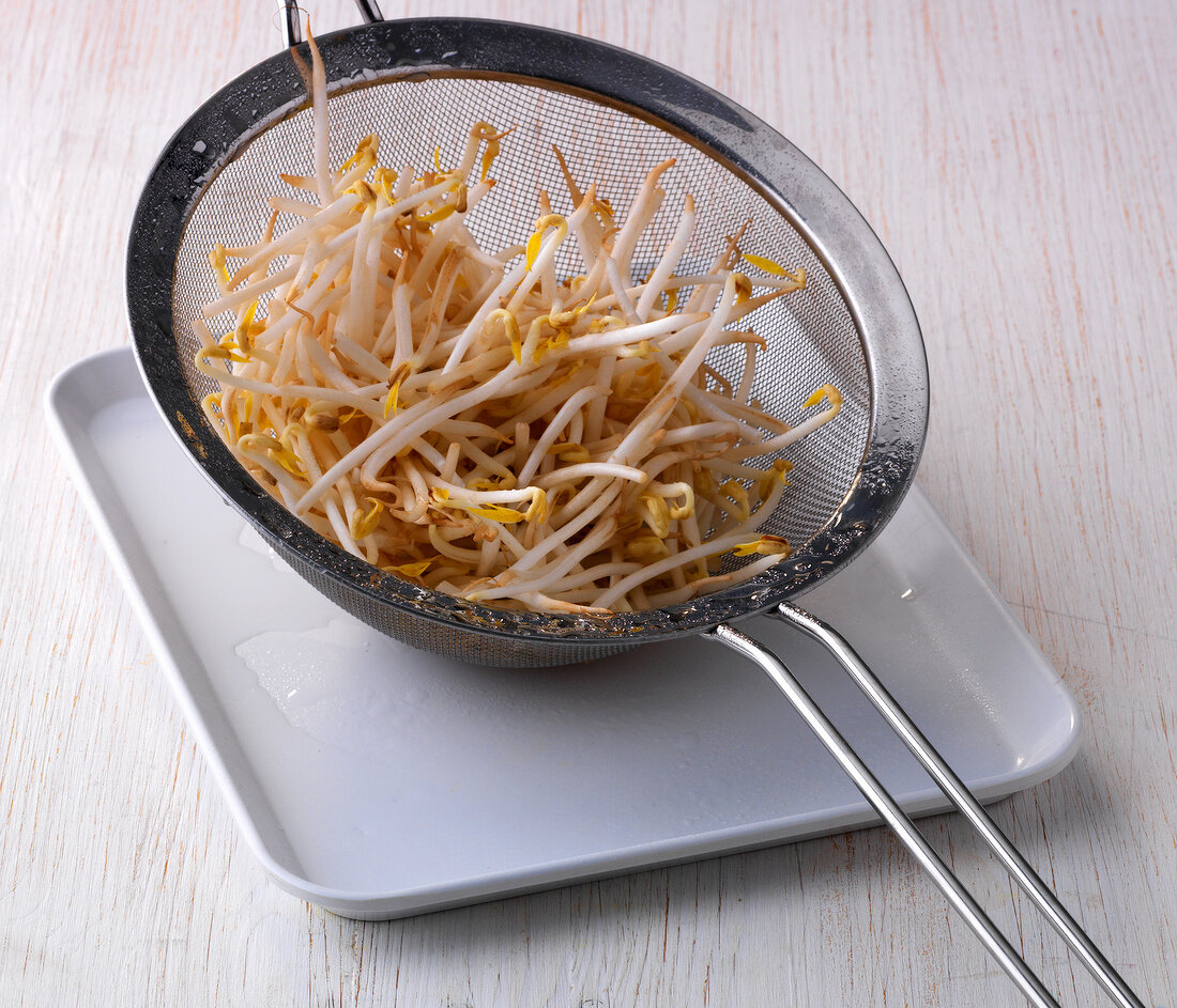 Bean sprouts in colander on plate