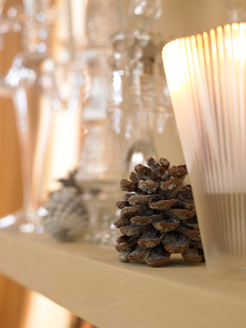Close-up of pine cones with candle stand on table
