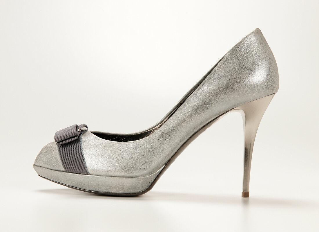 Silver high heels shoes on white background