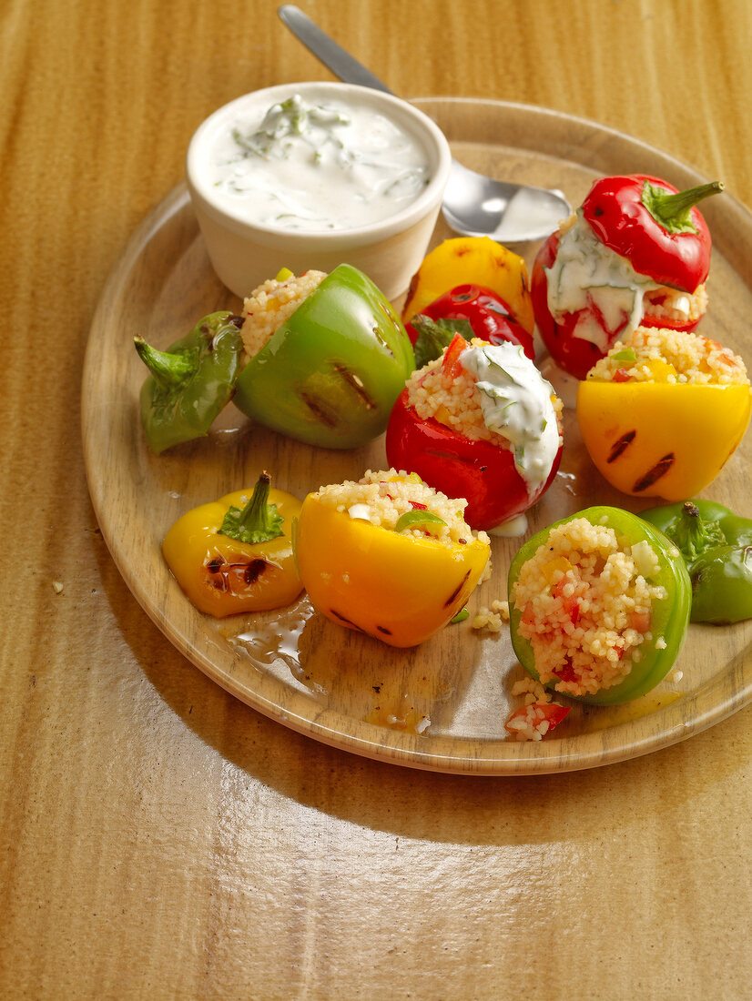 Mini peppers filled with couscous and yoghurt sauce on plate