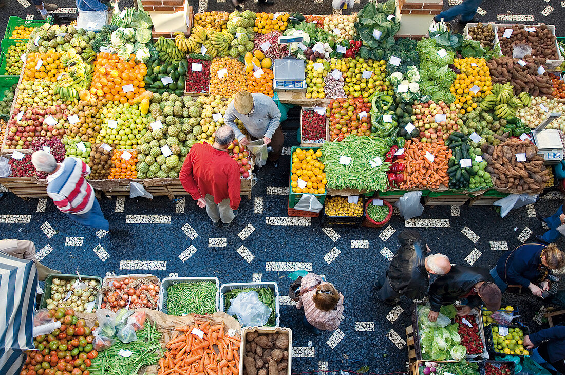Overhead view of people and different fruits and vegetables in Funchal, Madeira, Portugal