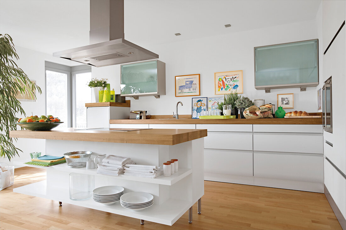 Kitchen in white with wooden flooring and working surface