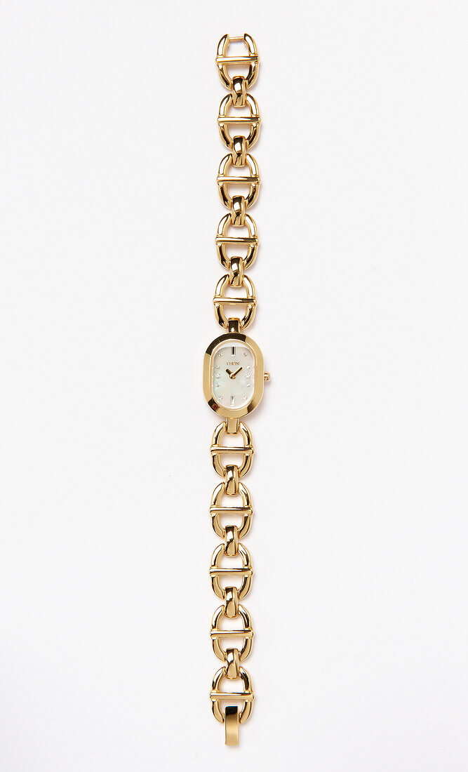 Close-up of small clock attached with bracelet on white background