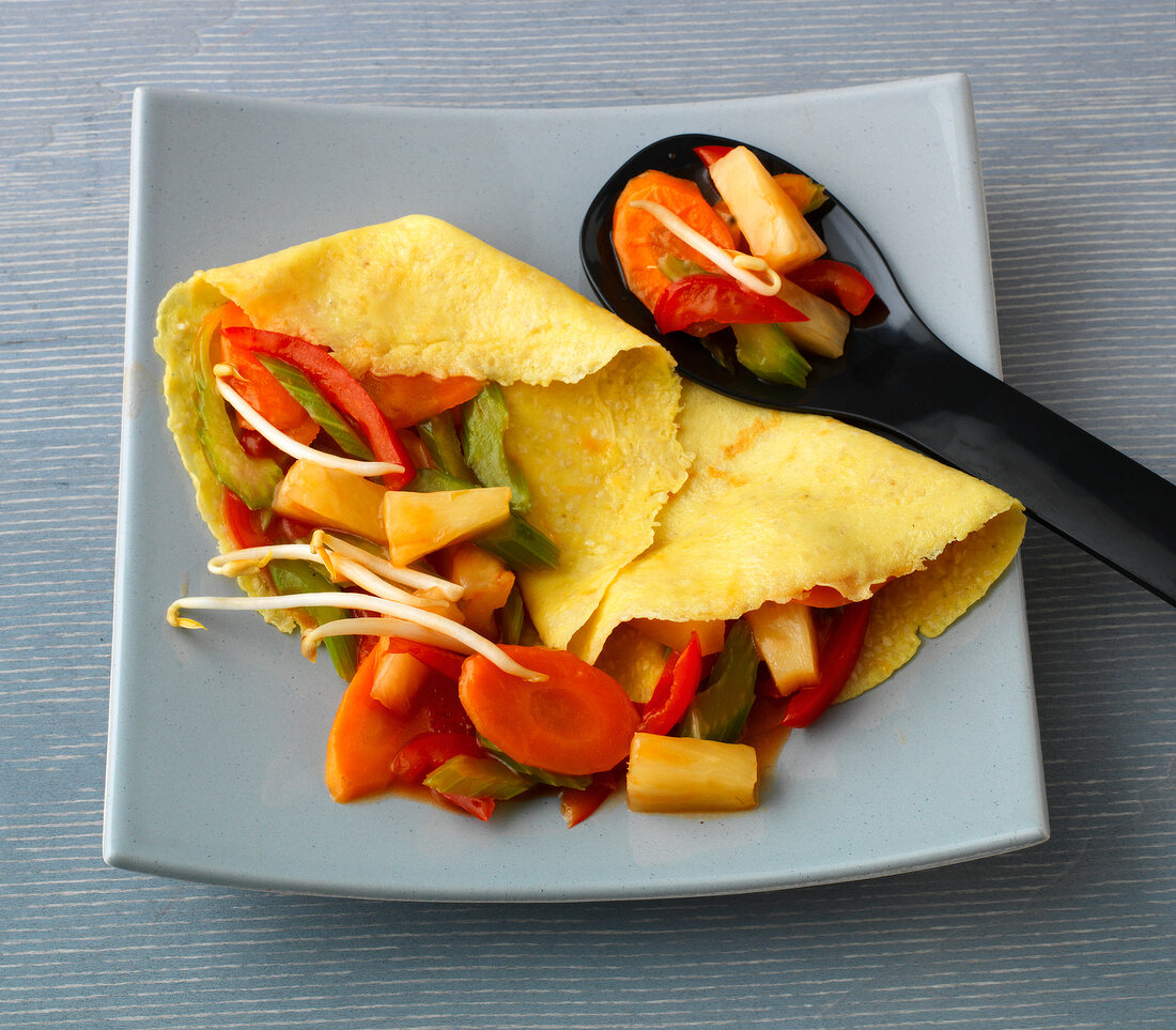 Sesame crepes with sweet and sour vegetables on plate