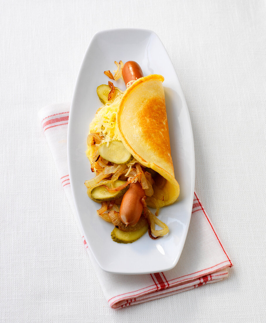 Pancake with hot dogs on plate
