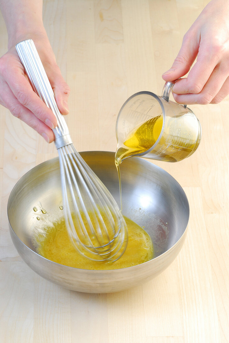 Whisking butter in bowl for preparing of artichoke salad with port wine mayonnaise, step 3