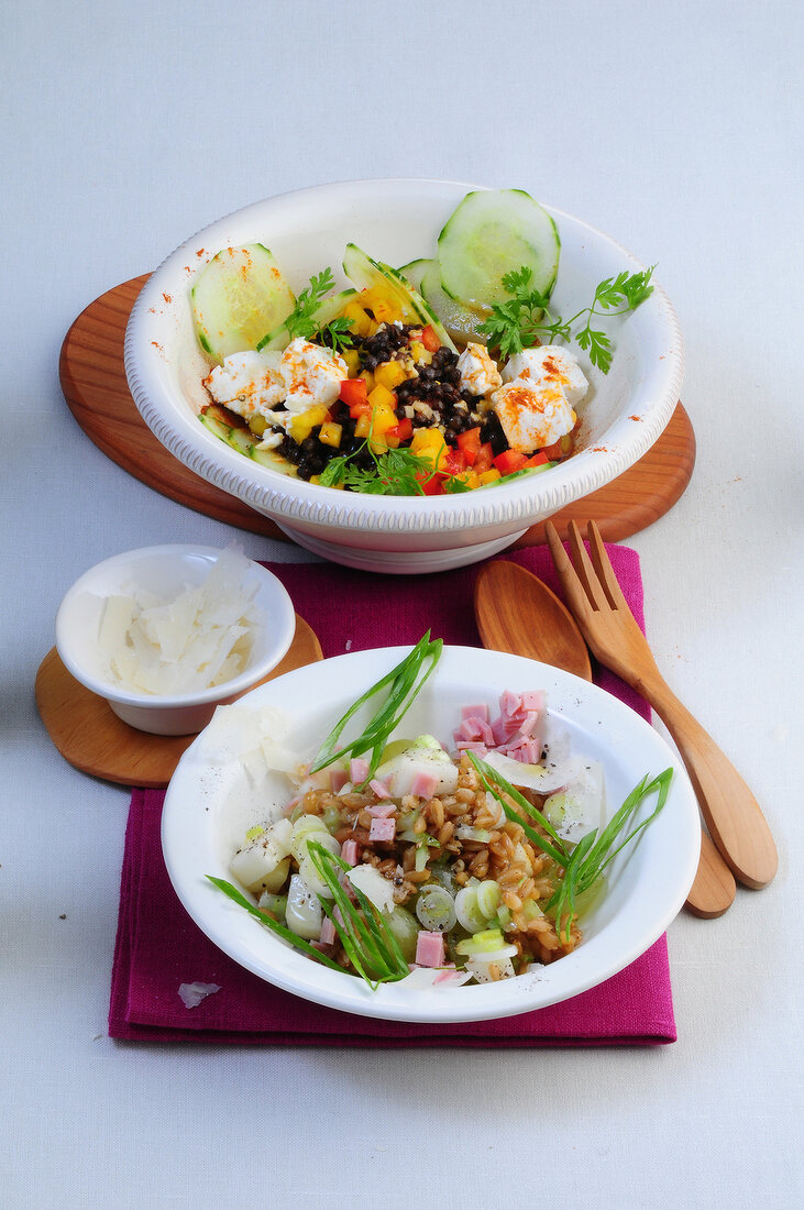 Black lentil salad and green core with pear salad in bowls